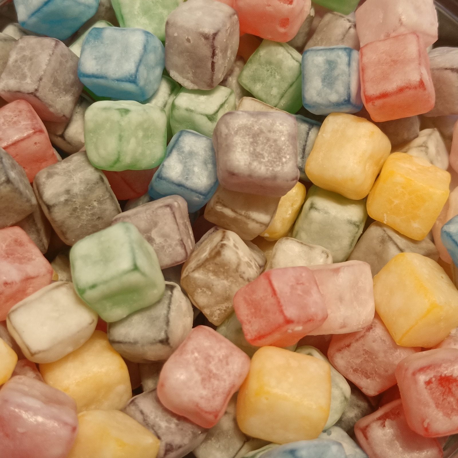 A close view of brightly colored gummy candy cubes, illustrating the gummy supplement format generally